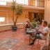 Il Palazzo Holiday Apartments Cairns courtyard seating area with two guests and tropical plants