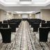 La Quinta Inn & Suites By Wyndham Dfw Airport South / Irving meeting room with rows of black chairs