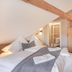 Hotel Engel in Sasbachwalden attic bedroom with exposed beam, twin beds, wardrobe, and bathroom door