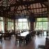 Seulawah Resort And Cafe in Batu: airy open-air cafe with wooden tables, chairs, and large windows