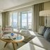 Cliff House Maine in Cape Neddick: ocean-view suite with fireplace, seating area, and balcony doors