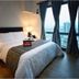 Home Edge Accommodations @ Tivoli Garden Residences Manila bedroom with city view and floor-to-ceiling windows