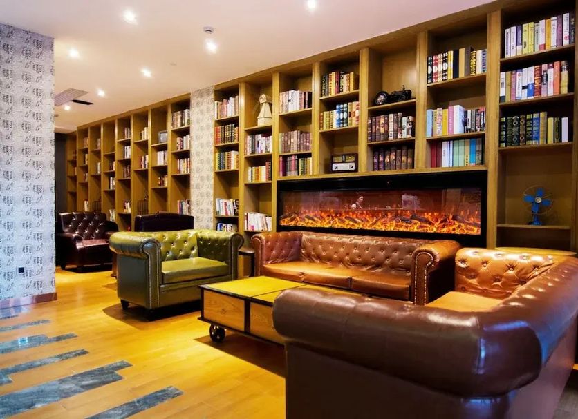 James Joyce Coffetel San Yuan LI Station Guangzhou library lounge with leather sofas and fireplace