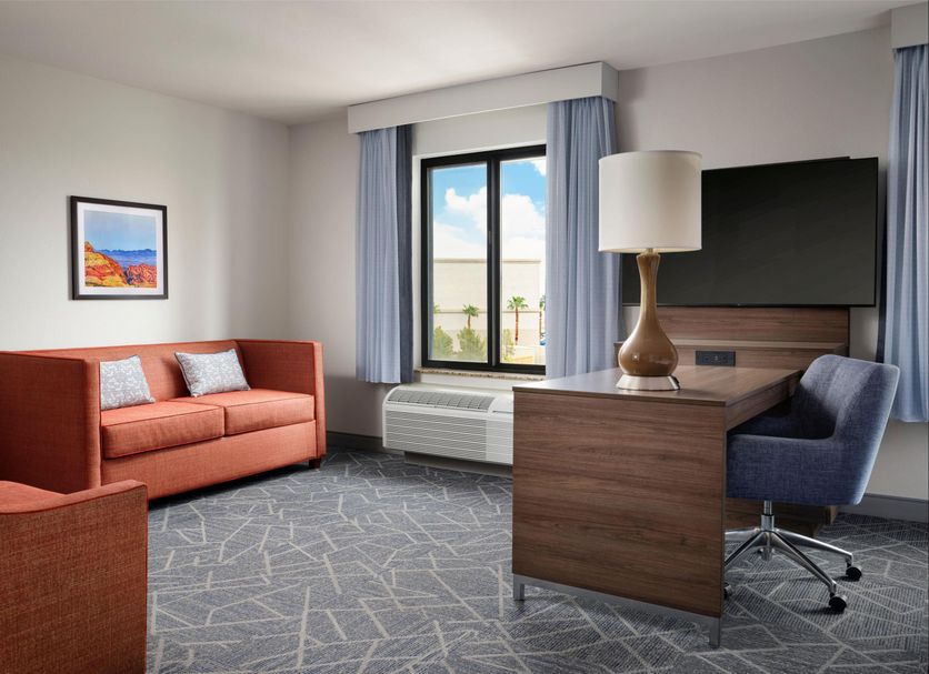 Hampton Inn & Suites Las Vegas-Red Rock/Summerlin room with sofa, desk, TV and window view