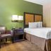 Extended Stay America Suites - Bakersfield - California Avenue room with queen bed, chair and bedside lamp