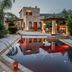 Olympia Villas in Stoupa, stone villa with lit pool, palm trees and mountain views
