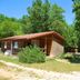 Lagrange Vacances Les Ségalières in Gramat, wooded chalet-style cabins with a sunny path
