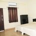 MM Tourist Home in Kāsaragod guest room with double bed, wardrobe and window AC