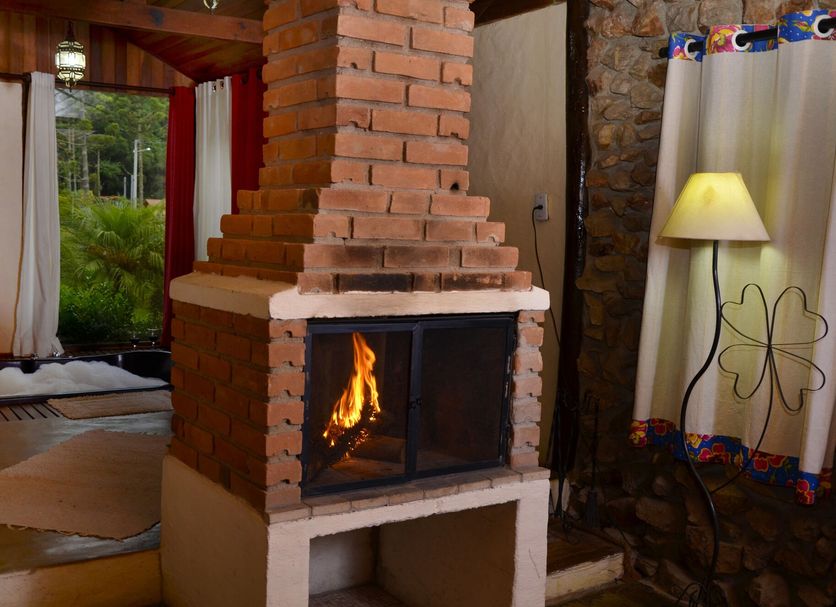 Pousada Silvestre in Resende, cozy room with brick fireplace and garden view