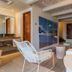 Hotel Boutique Bovedas de Santa Clara By Accor in Cartagena lounge with white sofa, woven chair and kitchen area