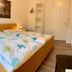 Gästehaus Seewarte in Flensburg guest room with double bed, bedside lamps, and wardrobe