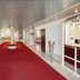 Living Hotel am Olympiapark in Munich lobby with red carpet, reception desk, and mirrored walls
