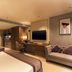 Grand Residency Hotel & Serviced Apartments in Mumbai guest suite with bed, desk, sofa and kitchenette