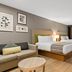 Country Inn & Suites by Radisson, Roanoke, VA guest room with two beds, sofa and large window
