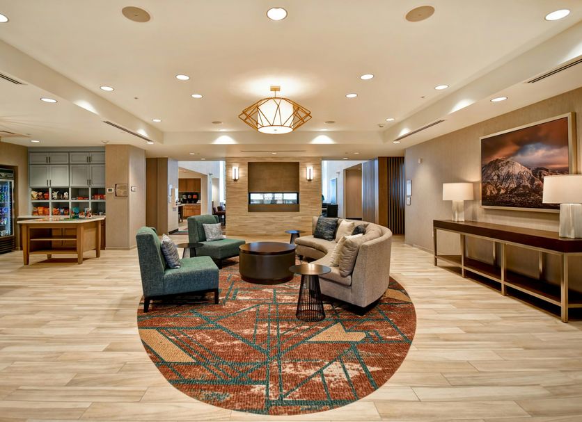Homewood Suites by Hilton Salt Lake City Airport lobby with seating area and warm lighting in Salt Lake City