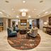 Homewood Suites by Hilton Salt Lake City Airport lobby with seating area and warm lighting in Salt Lake City