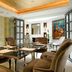 Althoff St James's Hotel & Club London meeting room with glass table, brown chairs and warm ceiling lighting in London