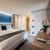 Hotel Principe Delle Nevi in Breuil-Cervinia: modern guest room with king bed and soft backlit headboard