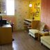 Time Motel in Gyeongju guest room with desk, chairs, and bright decorative wall art