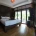Lipe Sunset Beach Resort room in Ko Lipe with king bed and balcony doors to greenery
