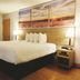 Days Inn by Wyndham Osage Beach Lake of the Ozarks guest room with king bed and lake sunset wall art