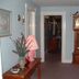 Windjammer BY The Sea, Hampton hallway with grandfather clock and floral decor