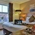 Westville Hotel Enniskillen guest room with double bed, window seating, and drinks on a bedside table