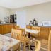 Breakfast area at Super 8 by Wyndham Ashland/Richmond in Ashland with tables and self-serve coffee station