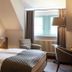 Schloss Hotel Dresden Pillnitz room with twin beds, armchairs, window seat and window in Dresden