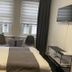 Altstadt-Hotel Gosequell room in Goslar with double bed, seating nook by window, and wall-mounted TV