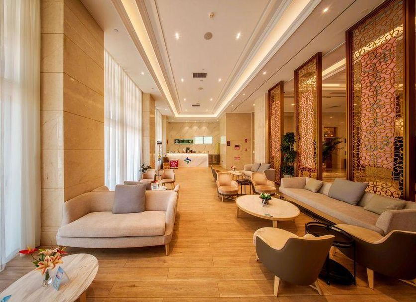 Guanyuan Liusu Hotel in Suzhou lobby lounge with sofas, chairs, and tall windows