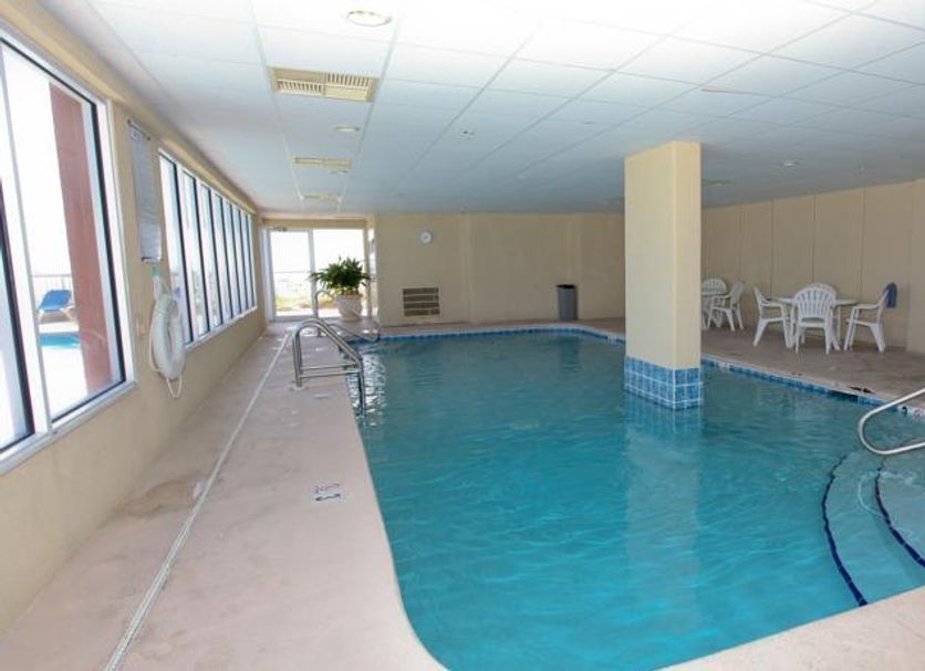 Indoor pool at Royal Palms by Wyndham Vacation Rentals in Gulf Shores with lounge chairs and seating