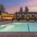 Best Western PLUS Truckee-Tahoe Hotel poolside courtyard in Truckee at sunset with lit pool and lounge chairs