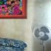Oasis Tepoztlán guest room with bed, bedside table, wall art, mirror and standing fan in Tepoztlán