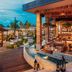 Jungala Hotel at VidantaWorld Riviera Maya in Cancún with outdoor dining and lagoon-side seating at sunset