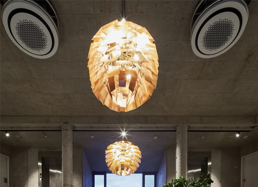 Flowers Hotel Essen in Essen lobby with long dining table, checkered floor and hanging pendant lights