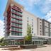 Hampton Inn & Suites Atlanta Buckhead Place exterior in Atlanta with modern facade and landscaped entrance