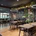 Woudschoten Hotel & Conferentiecentrum in Zeist dining area with modern tables, chairs and greenery divider