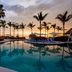 Hard Rock Hotel Vallarta in Nuevo Vallarta: sunset view of palm-lined pool with lounge chairs