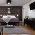 Hotel Flora and Fauna in Wimberley guest room with king bed, TV, desk and hardwood floors