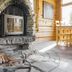 Basecamp Oulanka in Kuusamo, rustic lodge interior with stone fireplace and wood stack