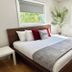 Cribs On The Hill in Picton: bright bedroom with queen bed, two windows, and a potted plant.