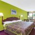 Super 8 by Wyndham Ashland/Richmond guest room with king bed, balcony door and seating area
