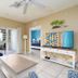 Harbour House At The Inn in Fort Myers Beach, living room with balcony and ocean view through sliding glass doors