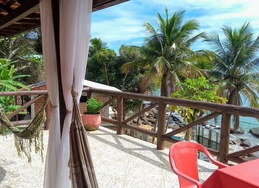 Pousada Mar de Araçatiba in Vila do Abraao, tropical balcony with wooden railing and ocean view
