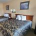 Mackinaw Budget Inn in Mackinaw City guest room with two double beds and framed wall art