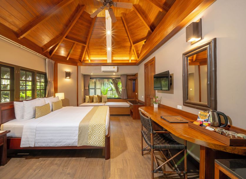 River Kwai Resotel in Sai Yok guest room with wooden vaulted ceiling, king bed, desk and river view