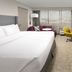 Crowne Plaza San Antonio Airport guest room with king bed, desk, TV, and seating area in San Antonio
