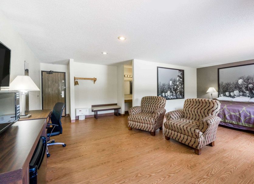 Super 8 by Wyndham Zanesville room with two armchairs, desk, and bed