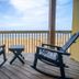 The Inn on Pamlico Sound in Buxton: two rocking chairs on a balcony overlooking the beach and ocean.